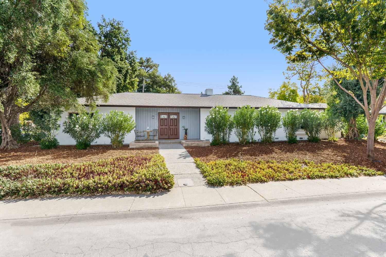 a front view of a house with garden