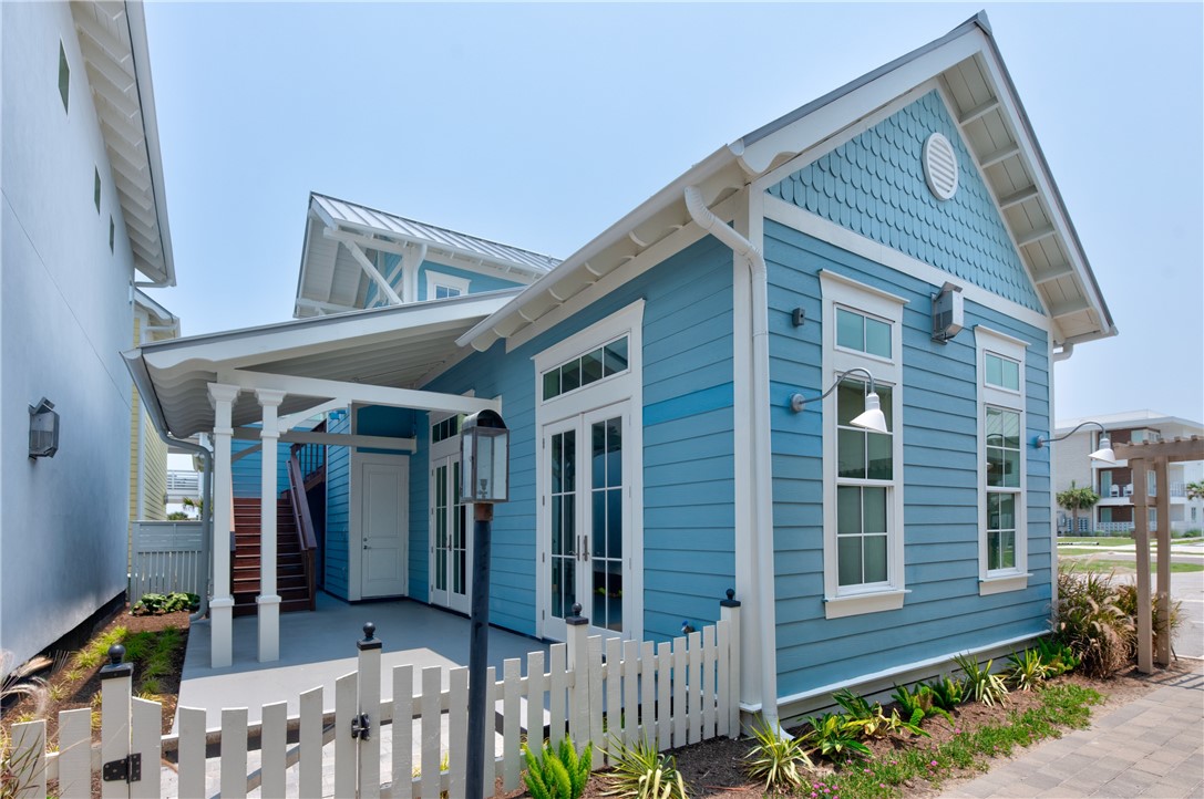 a view of a house with wooden fence