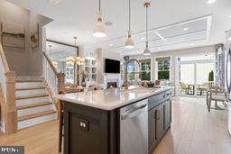 a kitchen with a sink and chandelier