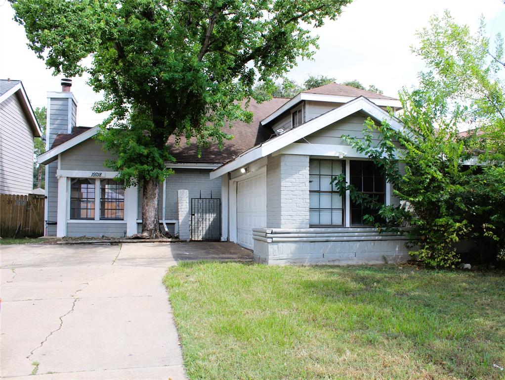 a front view of a house with a yard garage and outdoor seating