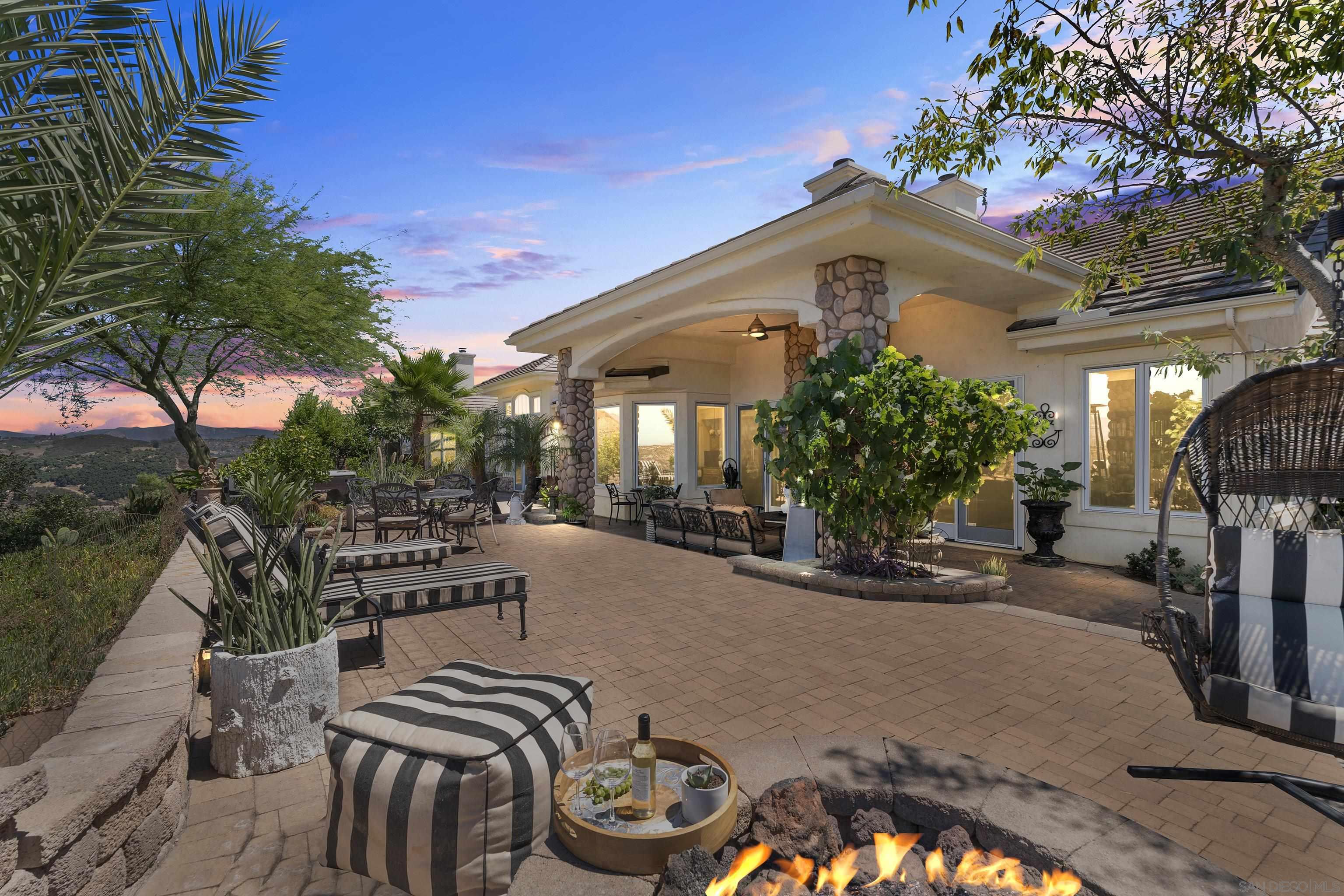 a view of a house with backyard and sitting area