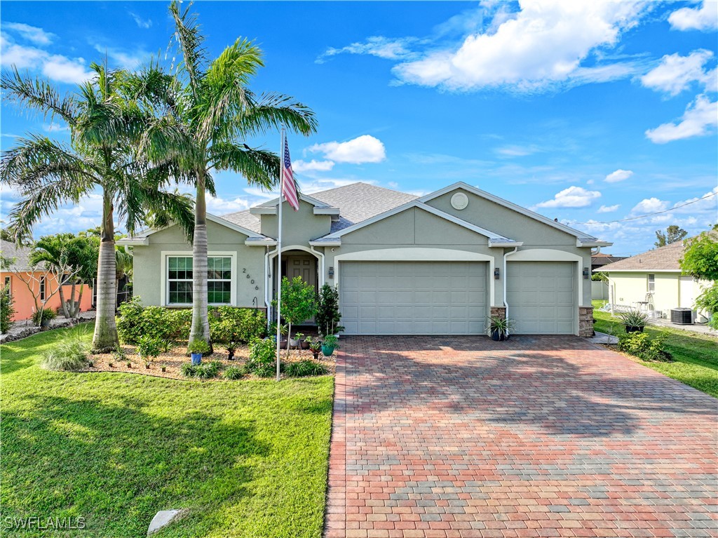 a front view of a house with a yard and garage