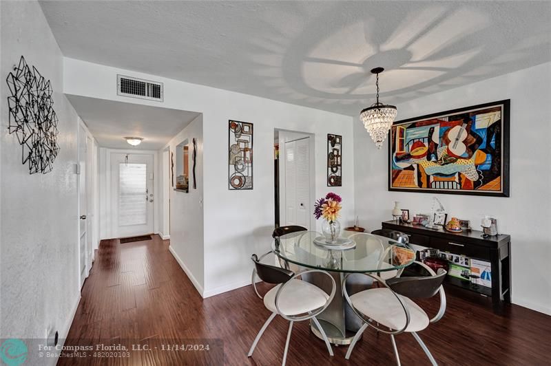 a view of a dining room with furniture wooden floor and chandelier