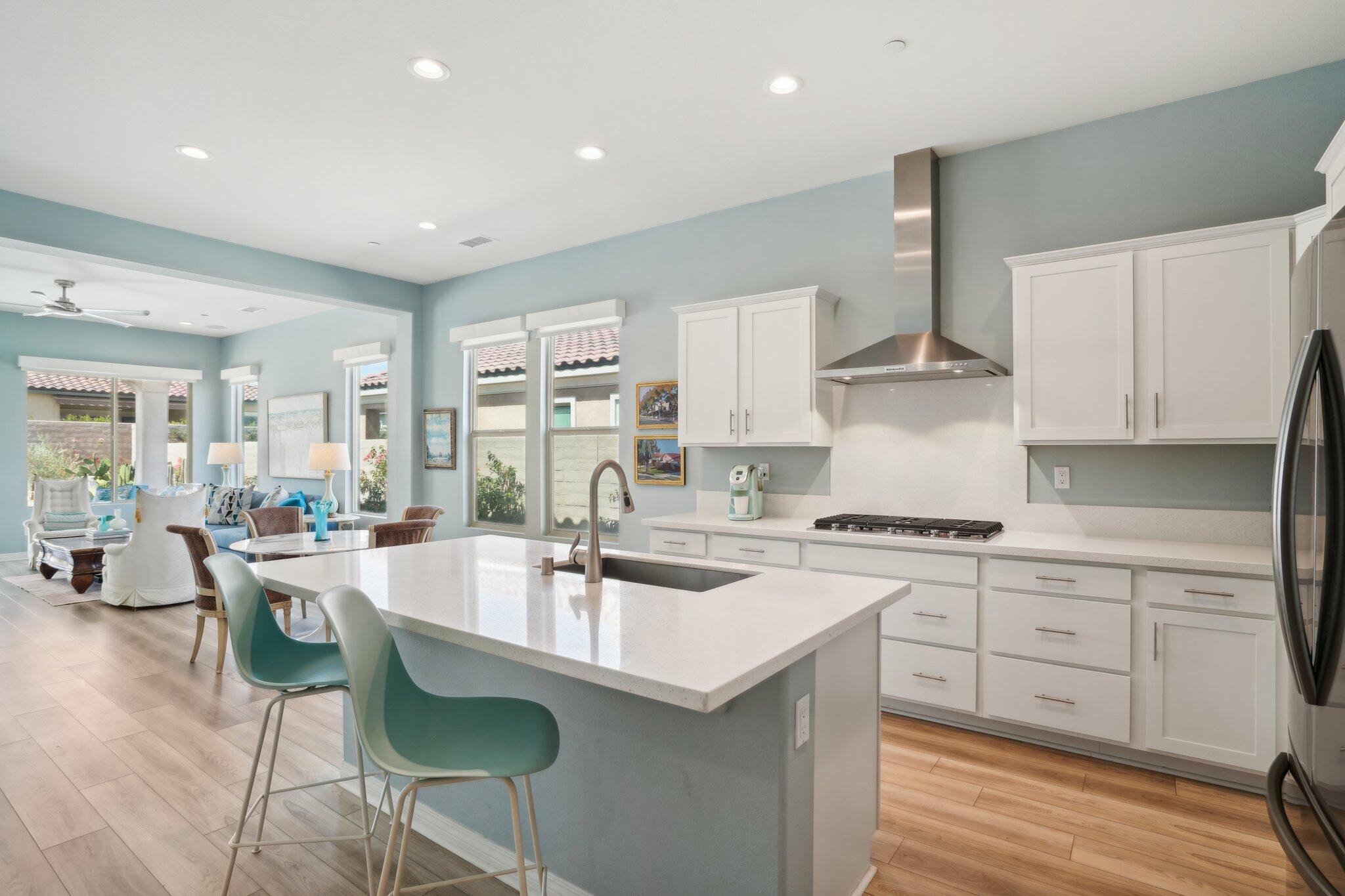 a kitchen with appliances a sink and cabinets