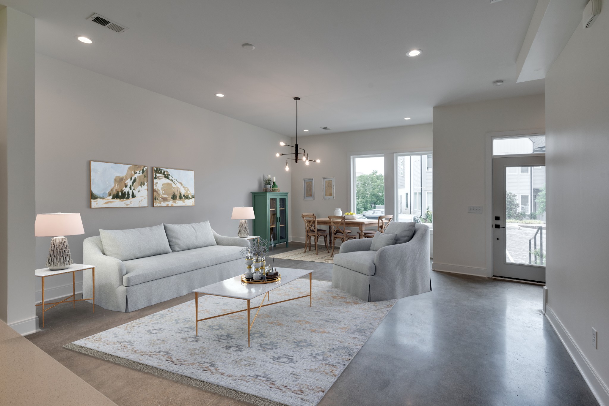 a living room with furniture and wooden floor