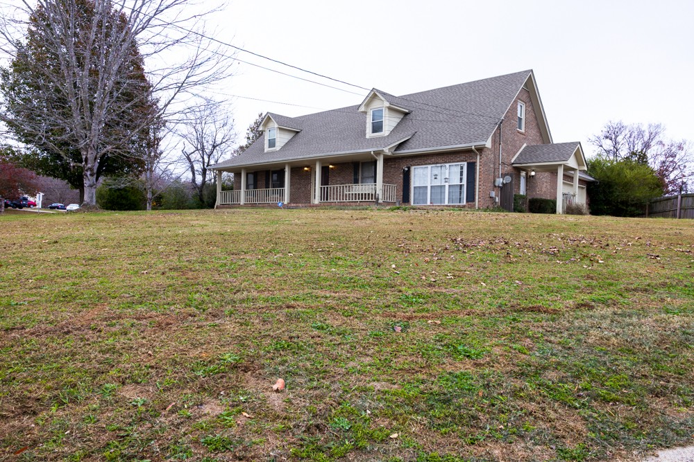 a front view of a house with a garden