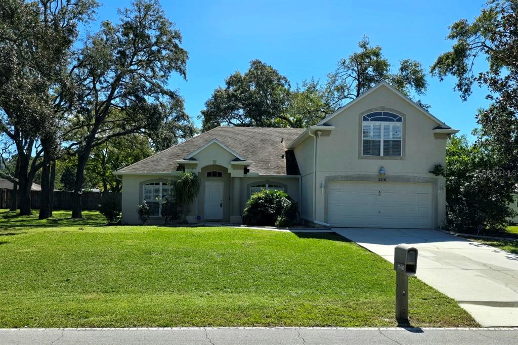 a front view of house with yard and green space