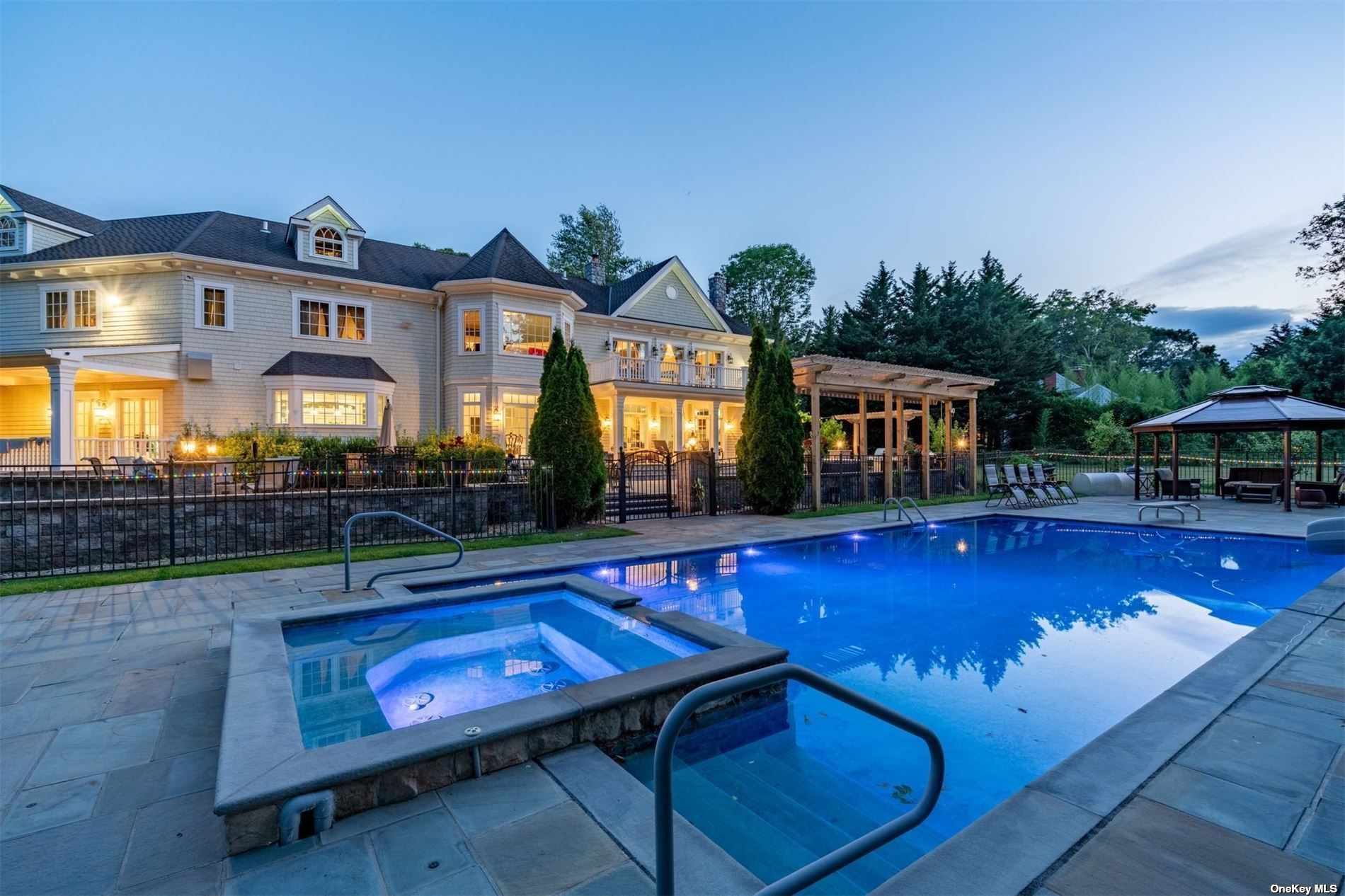 a view of a house with pool and chairs