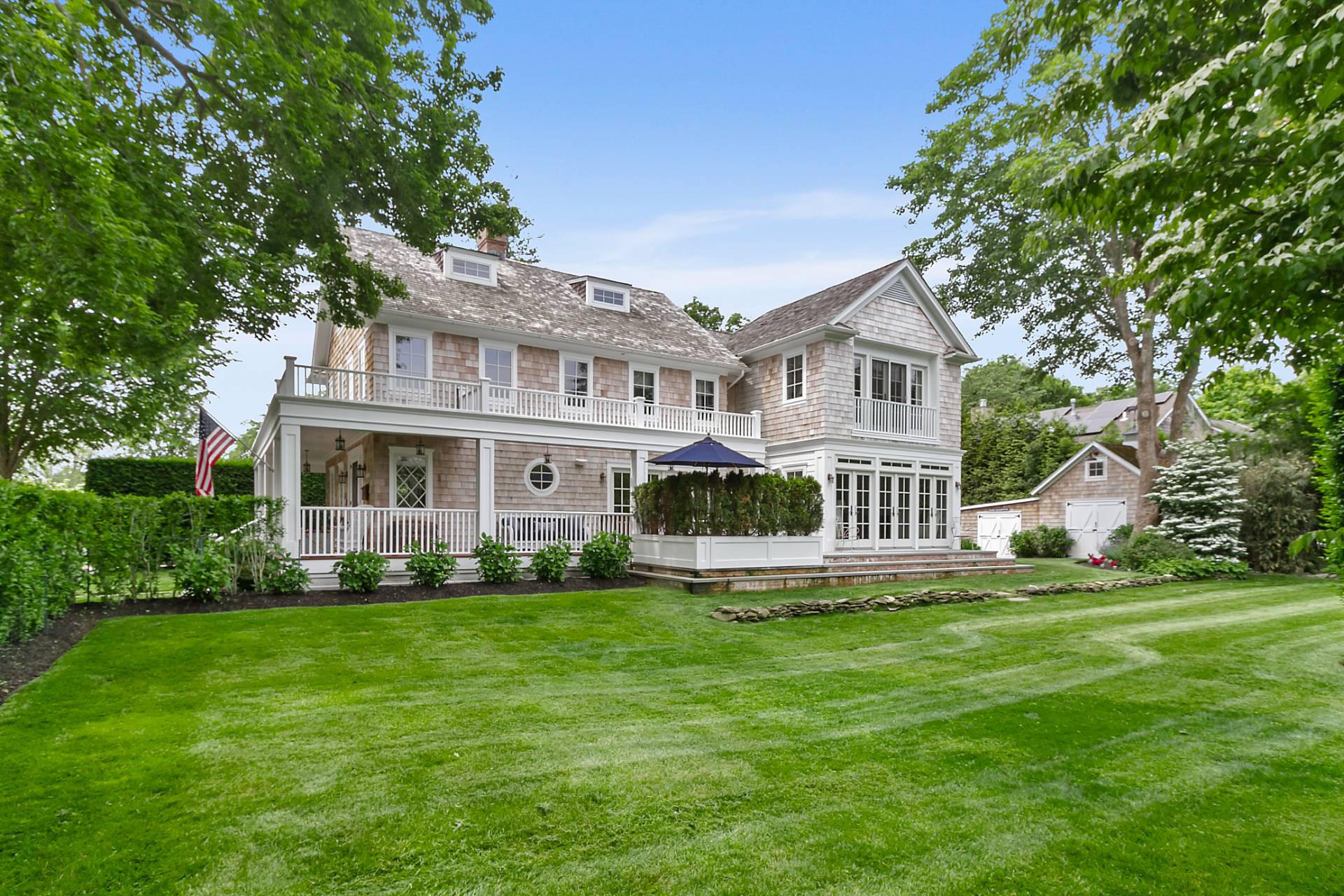 a front view of a house with a yard and trees