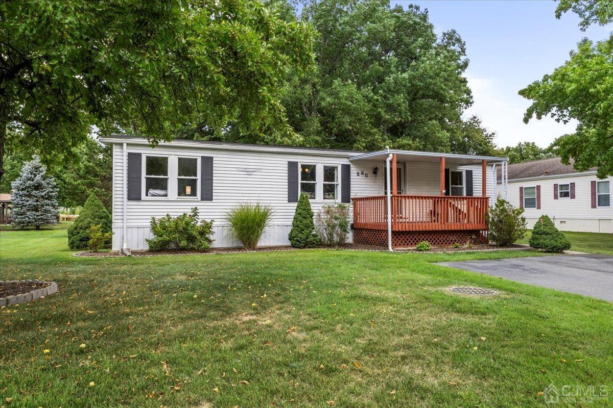 a front view of house with yard and green space