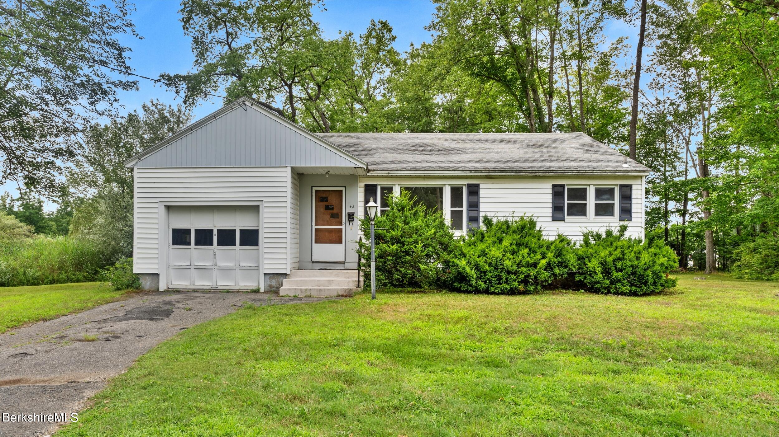 a front view of house with yard and green space