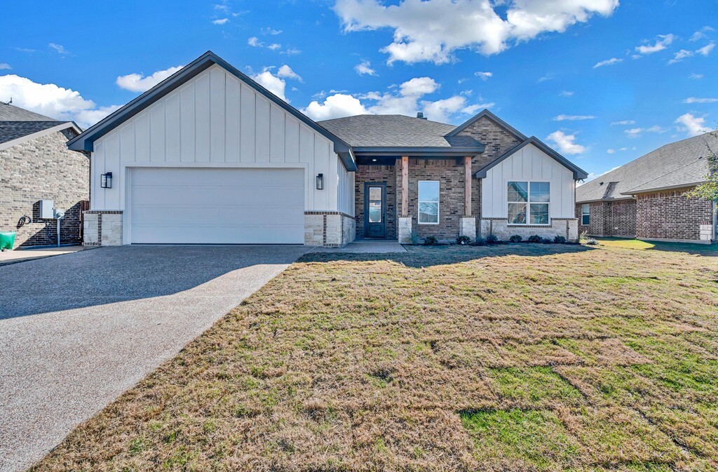 a front view of a house with a yard and seating space