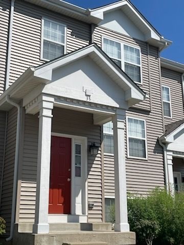 a view of a house with a garage and balcony