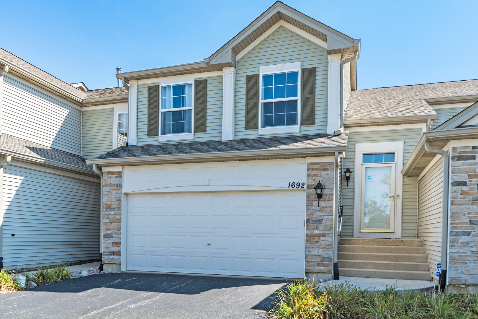 a front view of a house with a garage