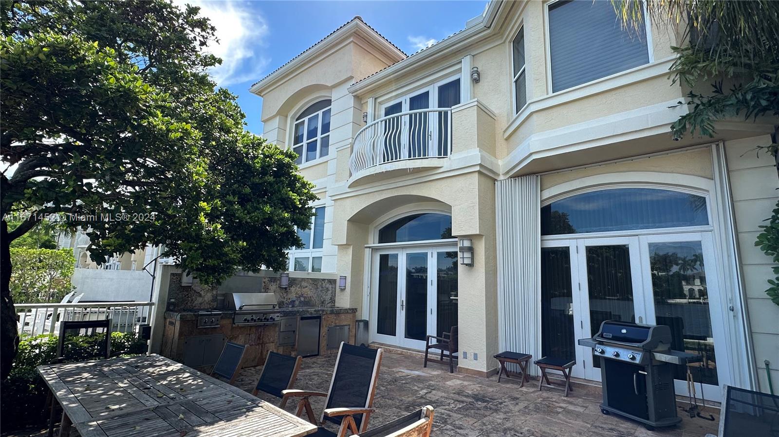 a front view of a house with outdoor seating