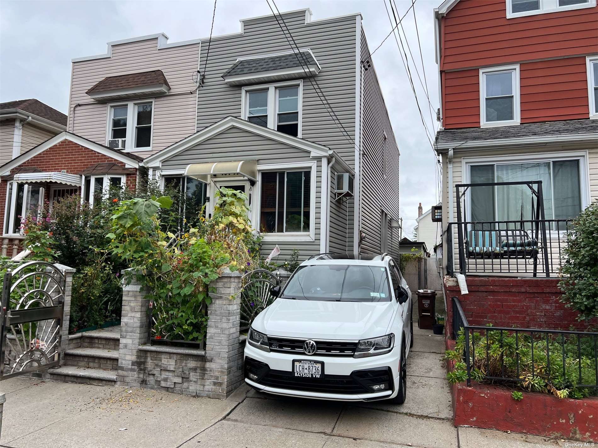 a car parked in front of a brick house