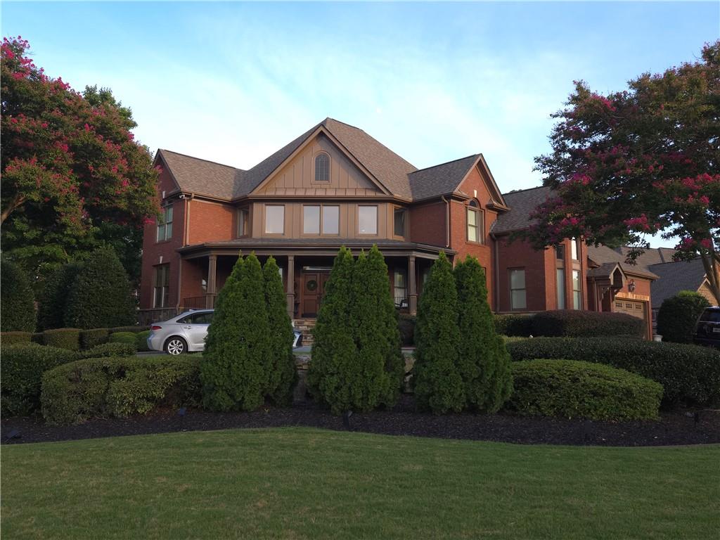 a front view of a house with a garden