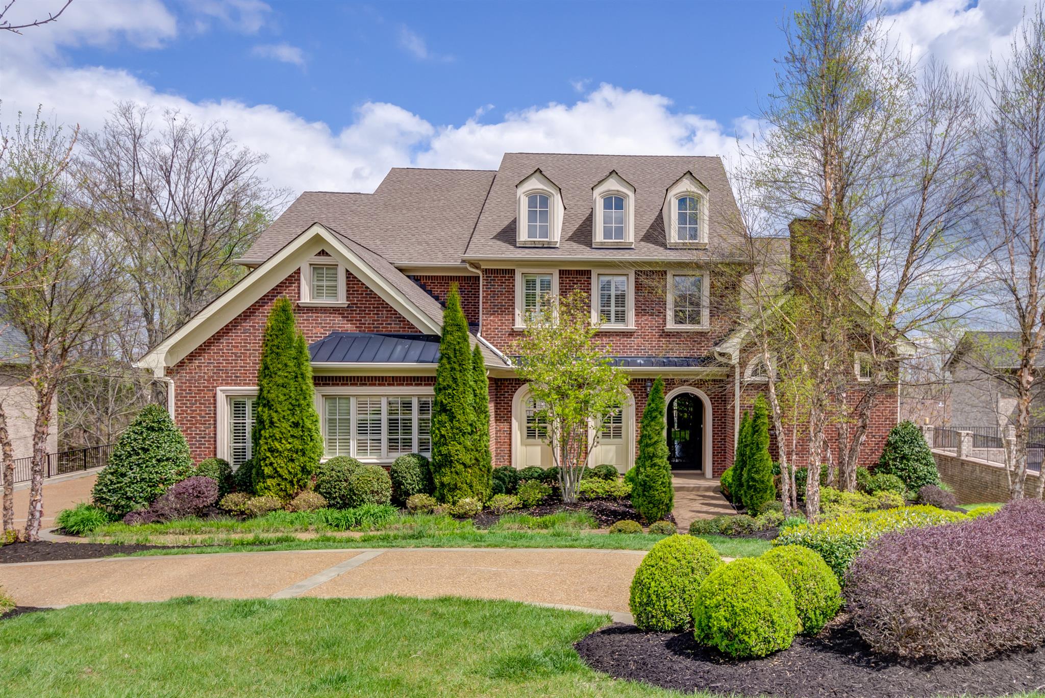 a front view of a house with a garden