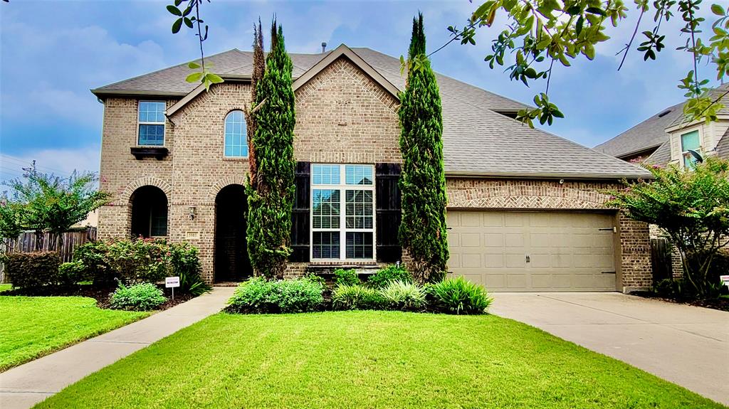 a front view of house with yard and green space