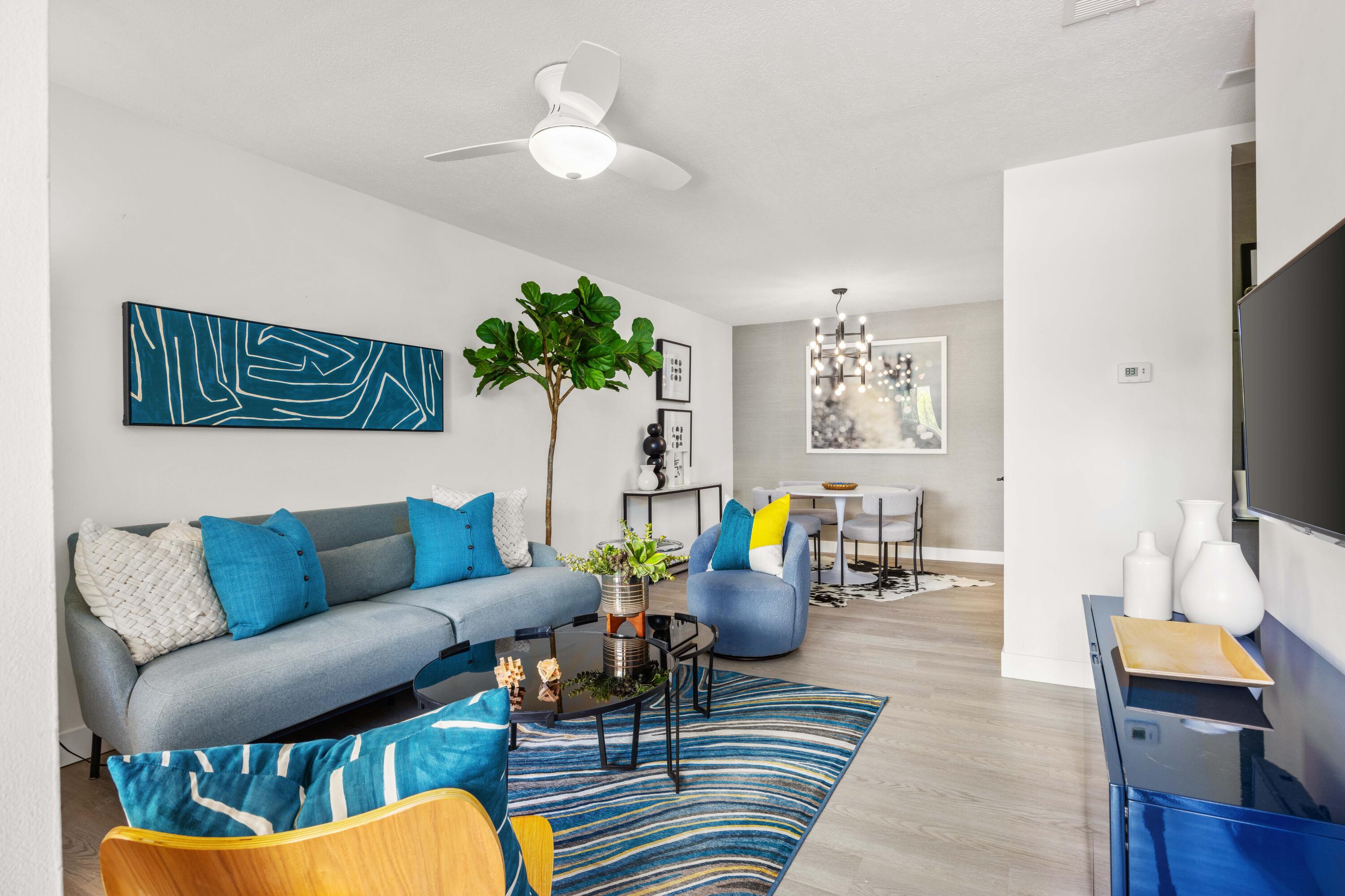 a living room with furniture a rug and a flat screen tv