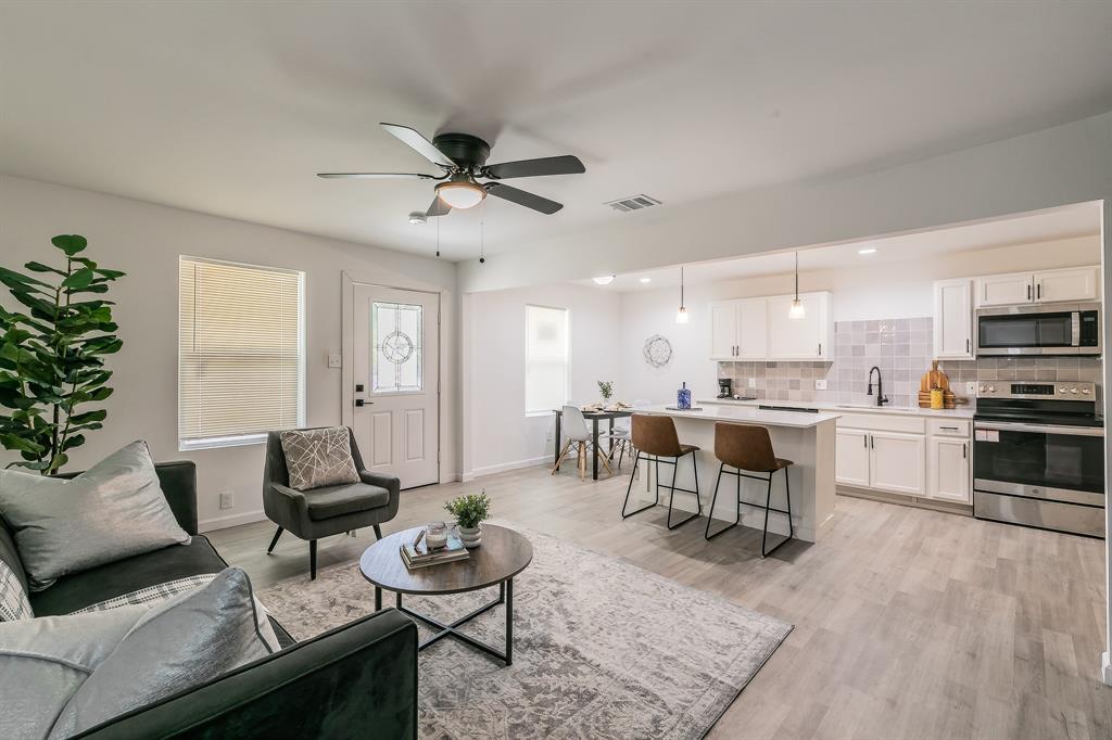 a living room with furniture and kitchen view