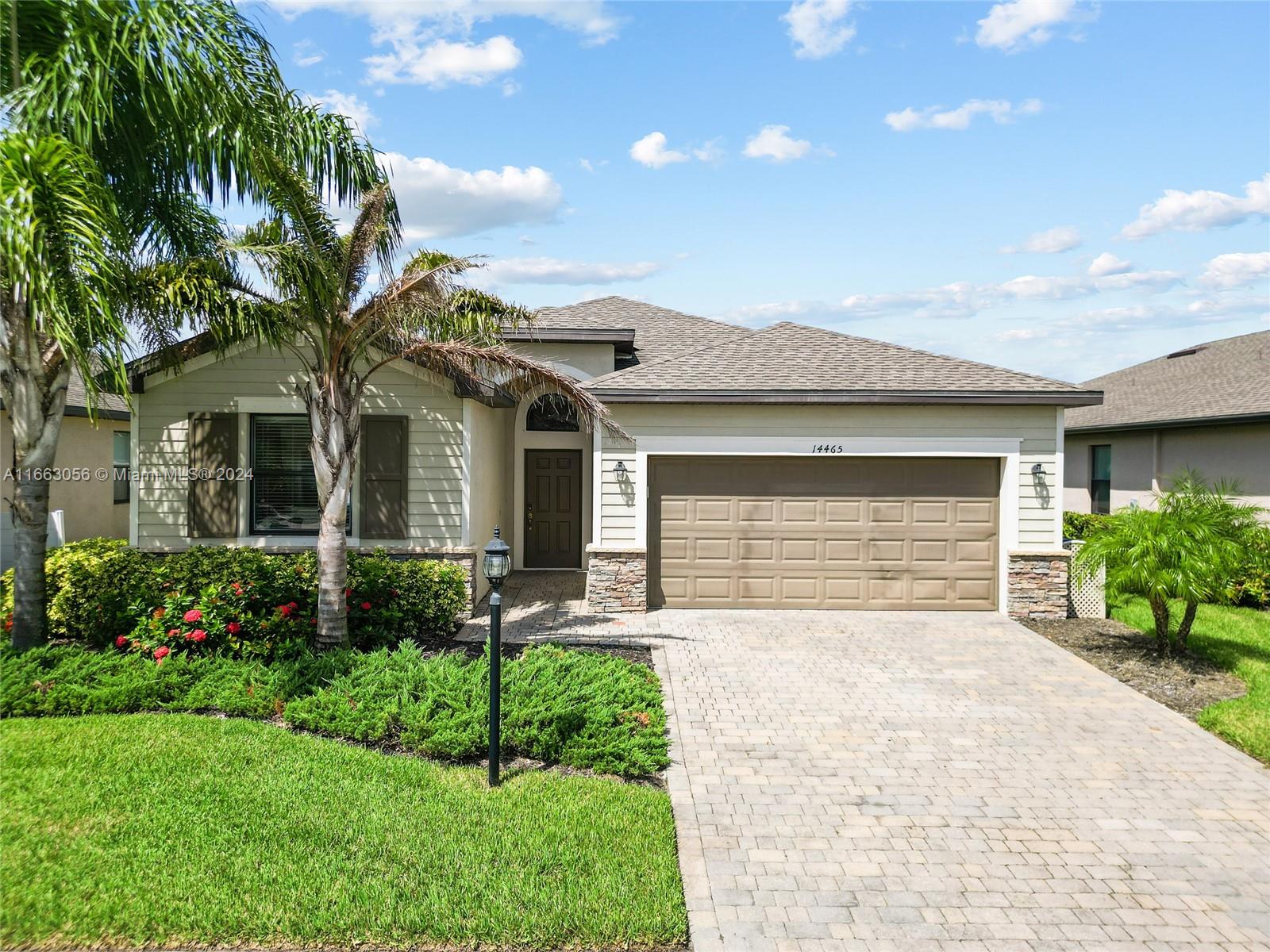 a front view of a house with a garden and yard