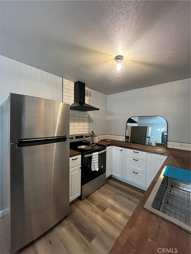 a kitchen with a refrigerator and a sink