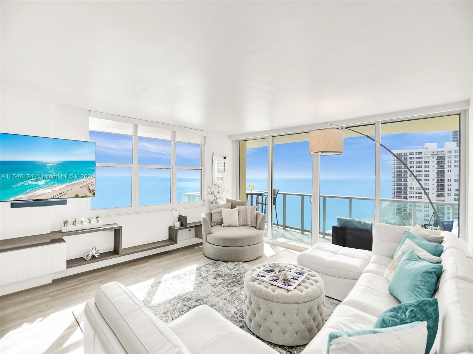 a living room with furniture and a large window