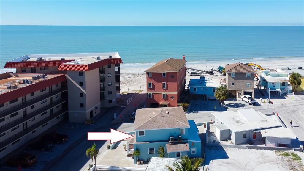 an aerial view of a house with parking space