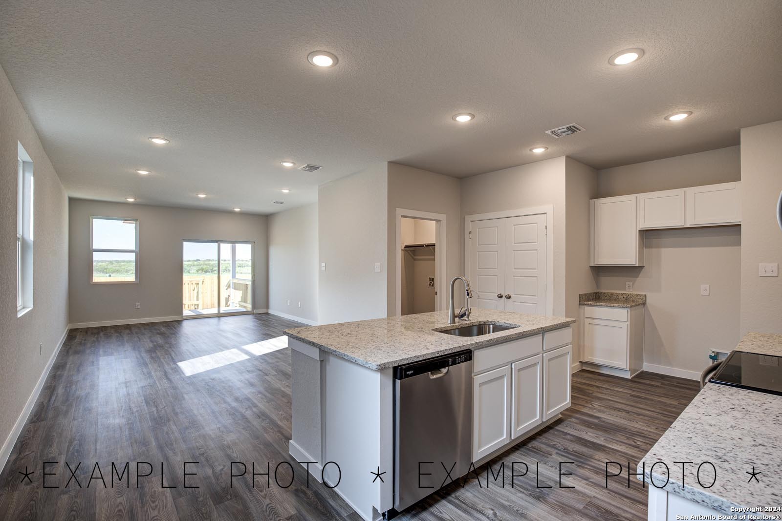 a kitchen with a sink stove and cabinets