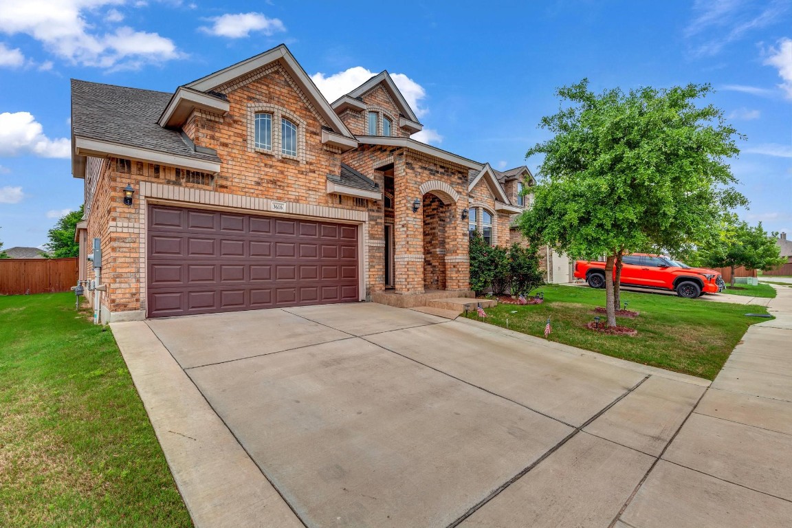 a front view of a house with a yard and garage