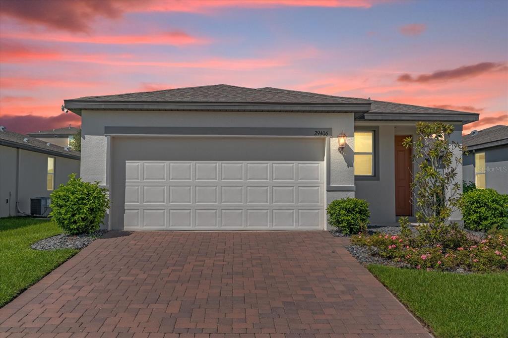 a front view of a house with a yard and garage