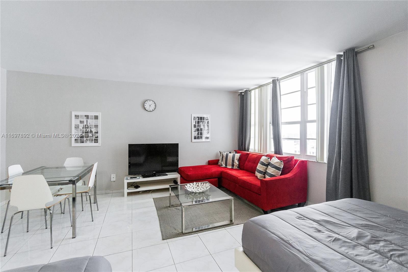 a bedroom with furniture and a flat screen tv