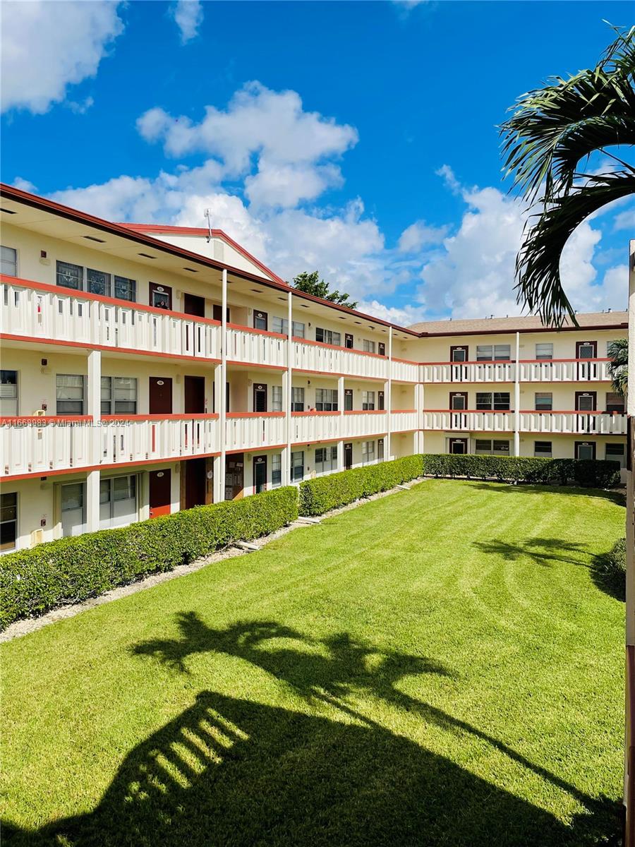 a view of a large building with a big yard