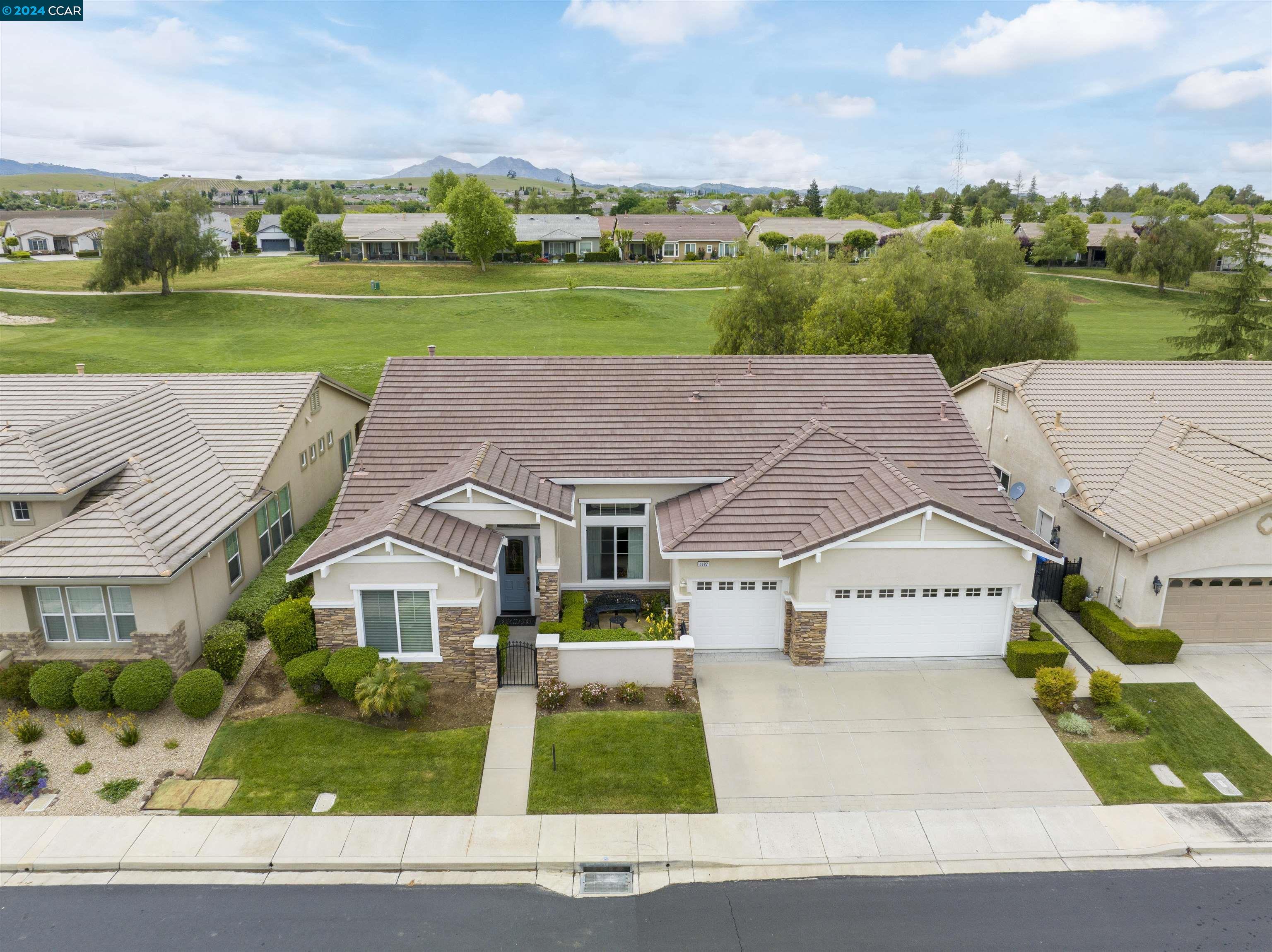 an aerial view of a house with a yard