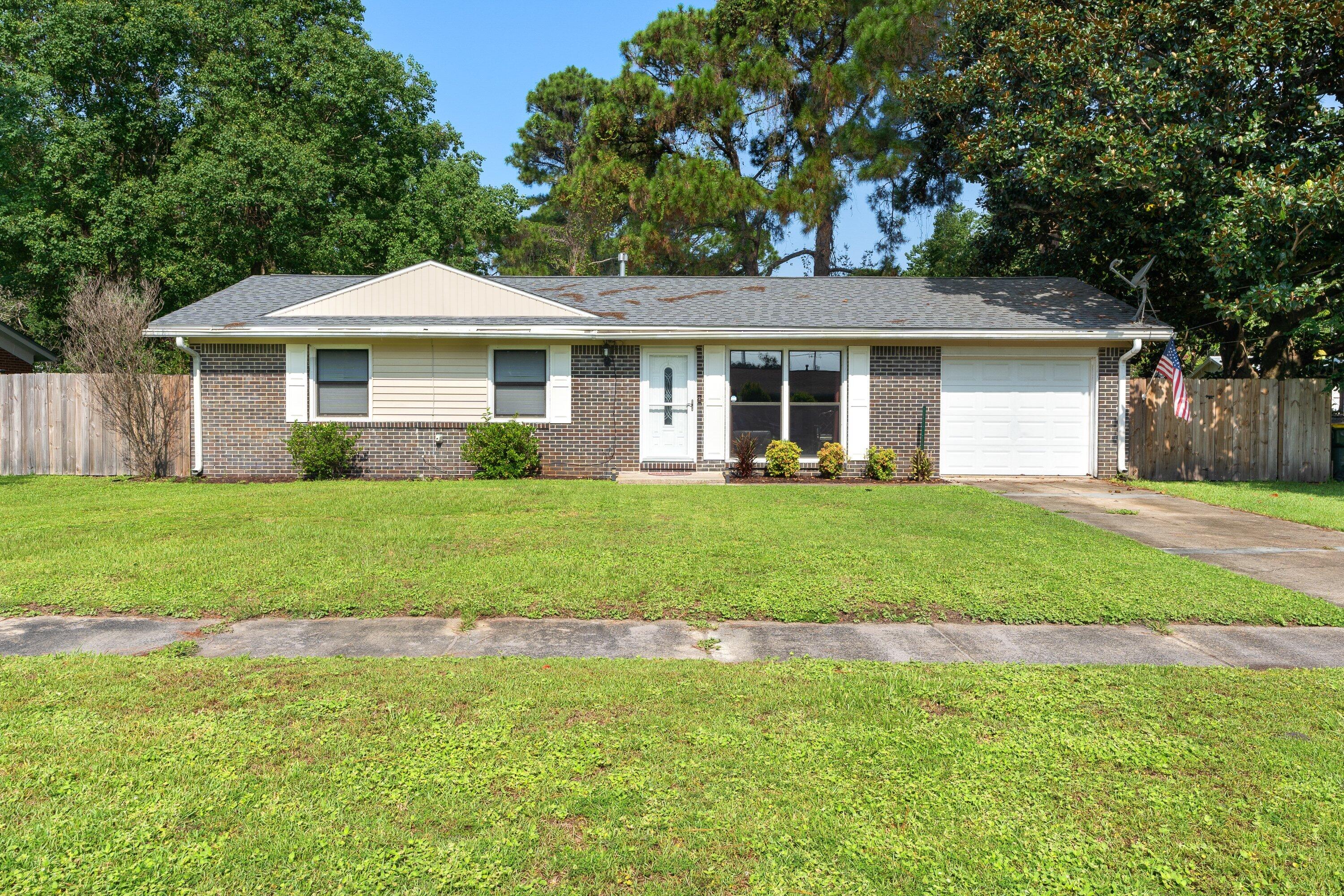 a front view of house with yard and green space