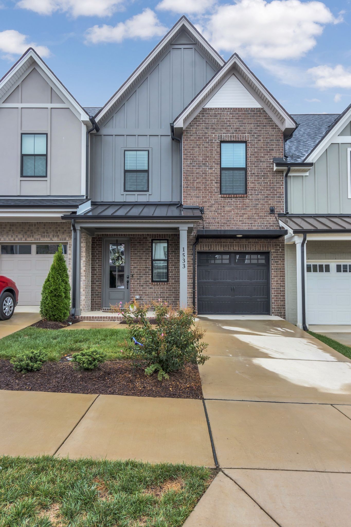 a front view of a house with a yard and a garage