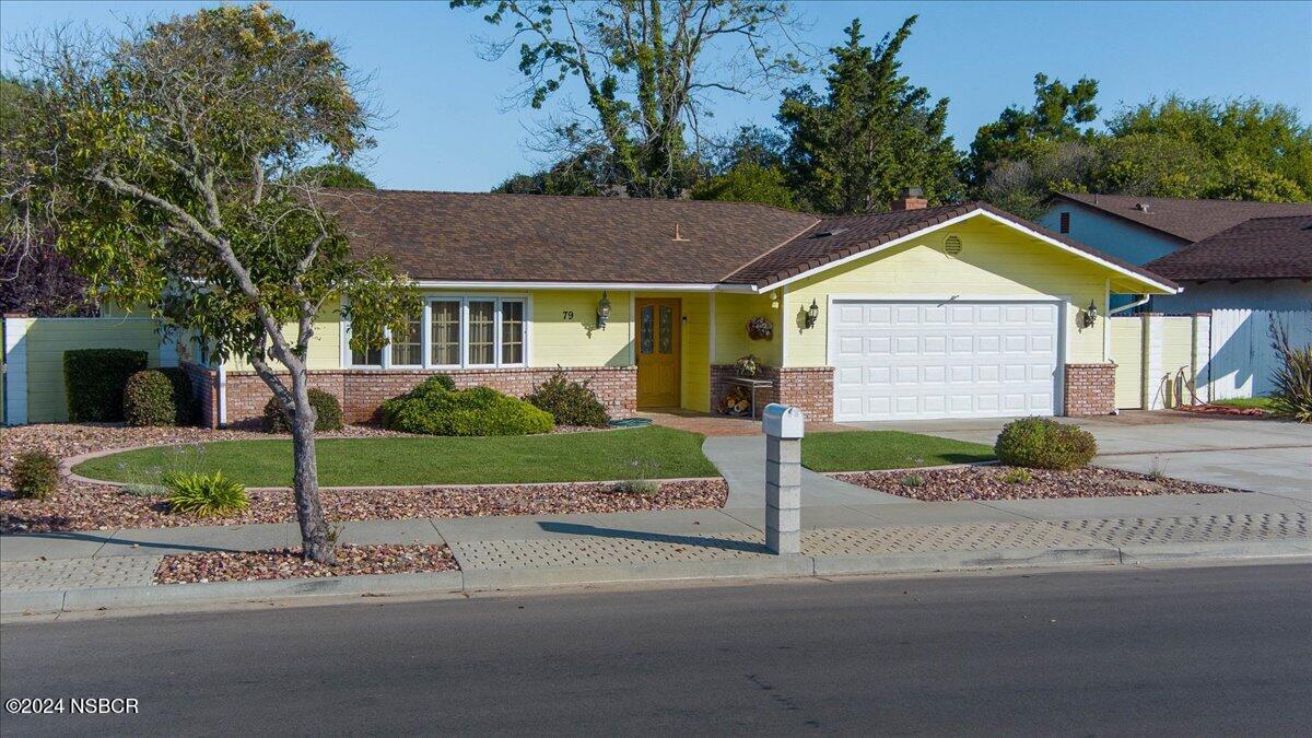 a view of a house with a yard and plants