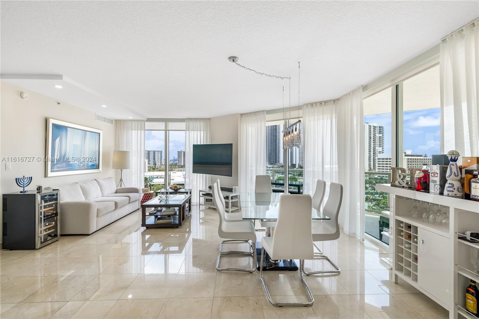 a living room with furniture large window and flat screen tv