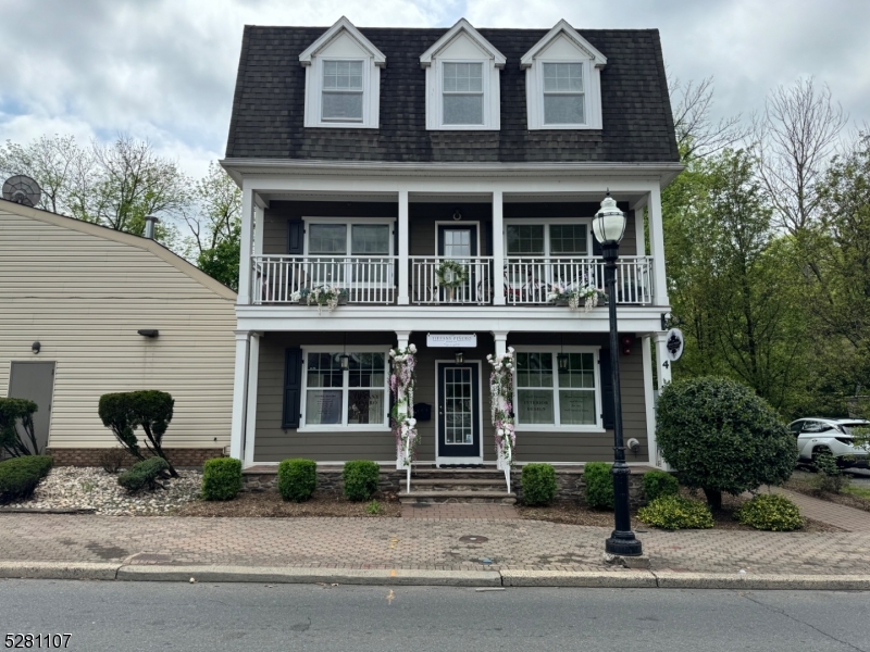 a front view of a house with a yard and windows