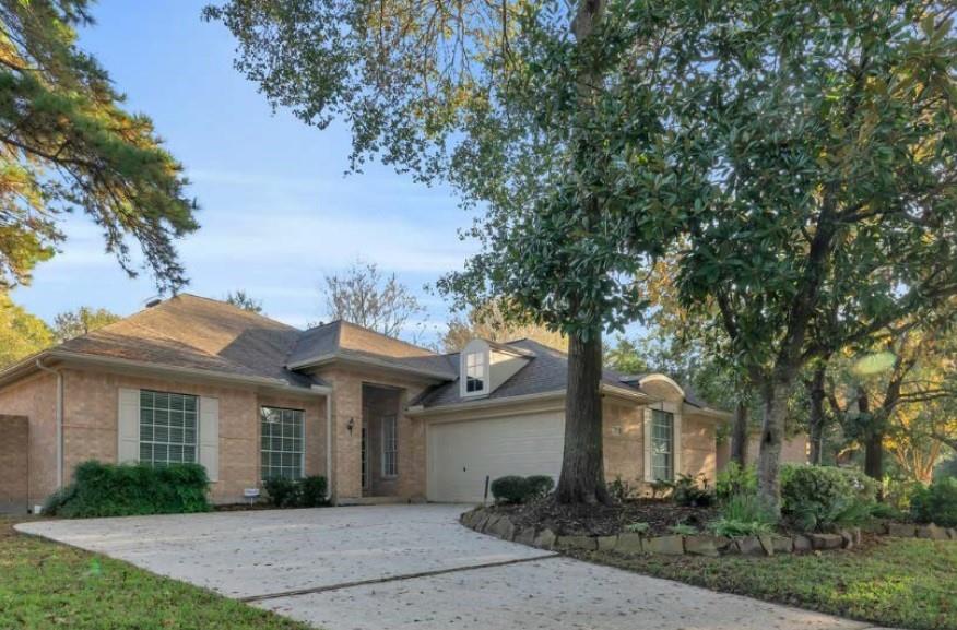 Front exterior with double lane driveway and side entry garage