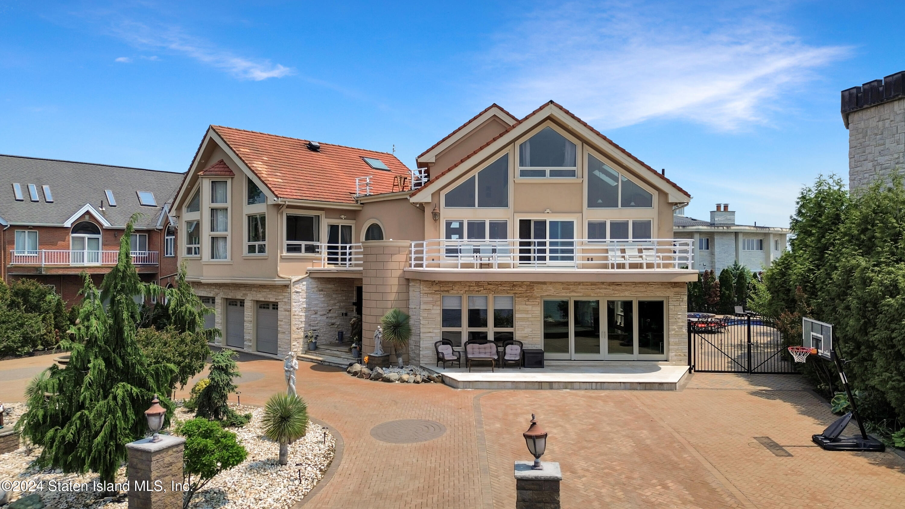 a front view of a house with yard and green space