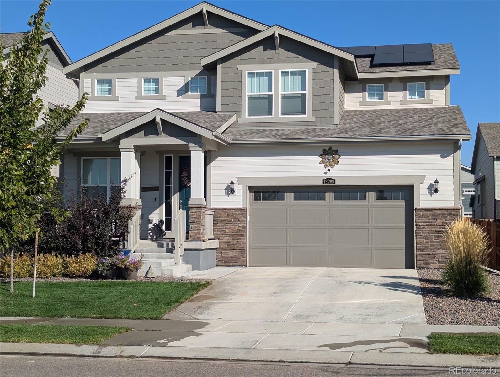 a front view of a house with a yard and garage