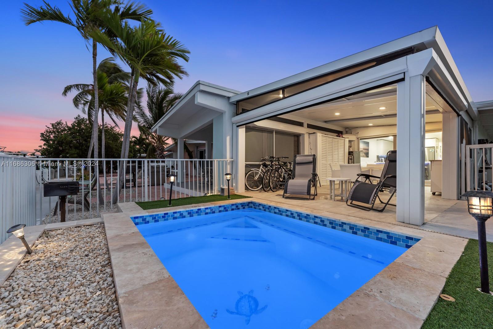 a view of a swimming pool with chair and table