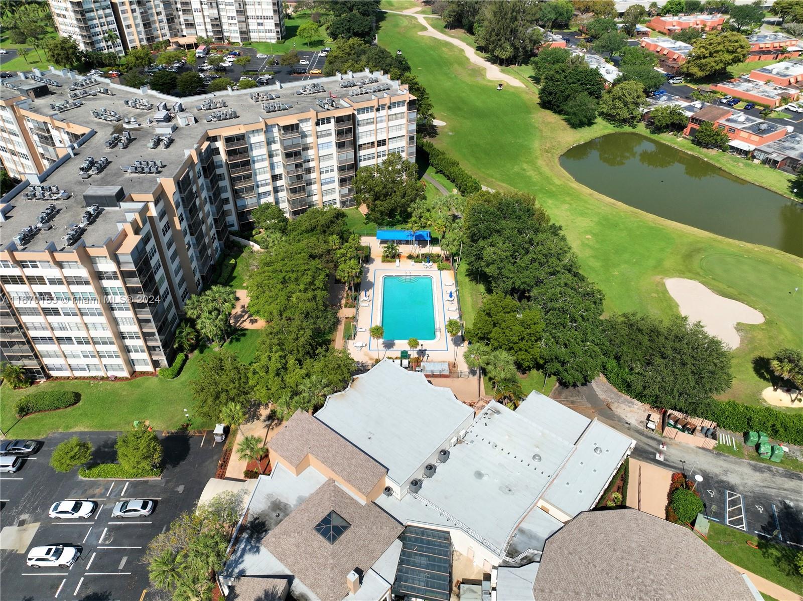 an aerial view of a house with a garden and lake view