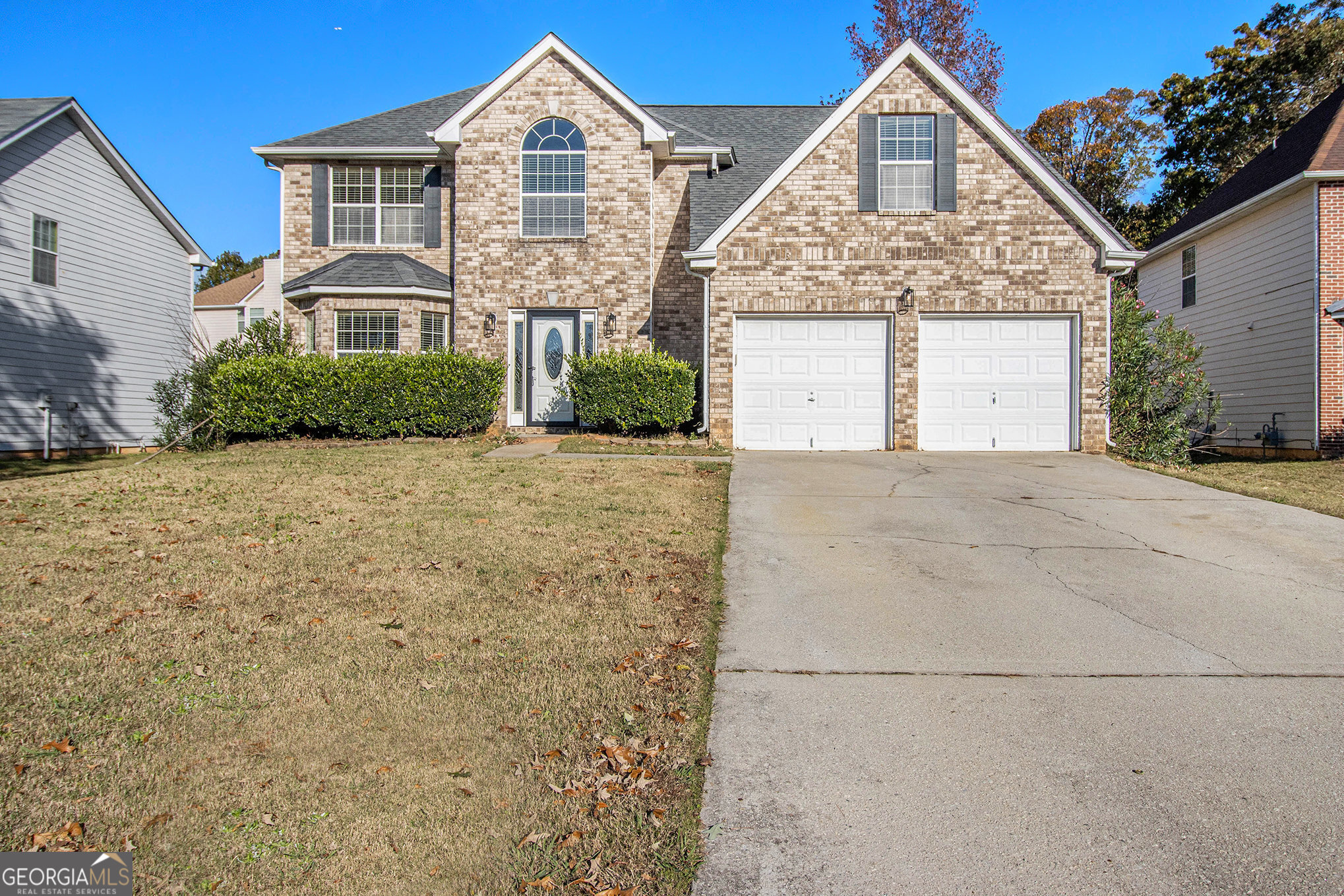 a front view of a house with a yard and garage