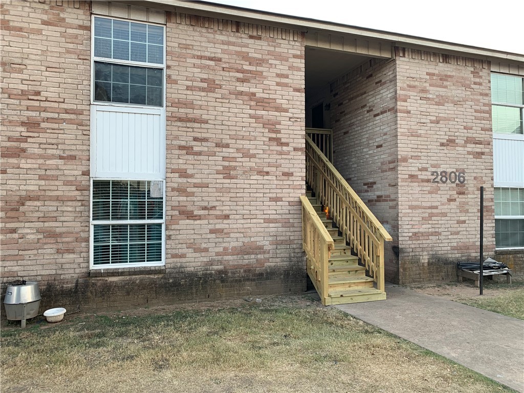 a view of front door of house with stairs