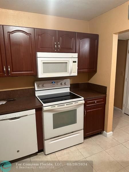 a stove top oven sitting inside of a kitchen