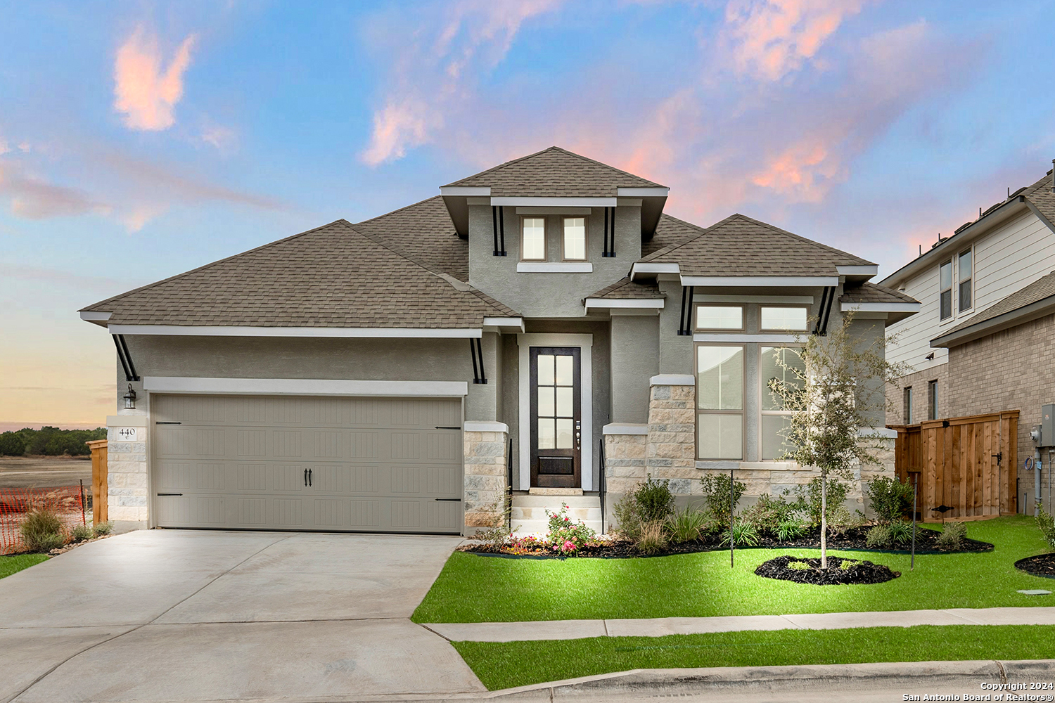 a front view of a house with a yard and garage