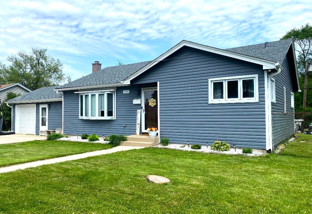 a front view of a house with a garden